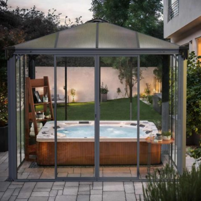 The Palram Ledro 3000 enclosed gazebo being used as a hot tub cover on a patio in a modern style garden.