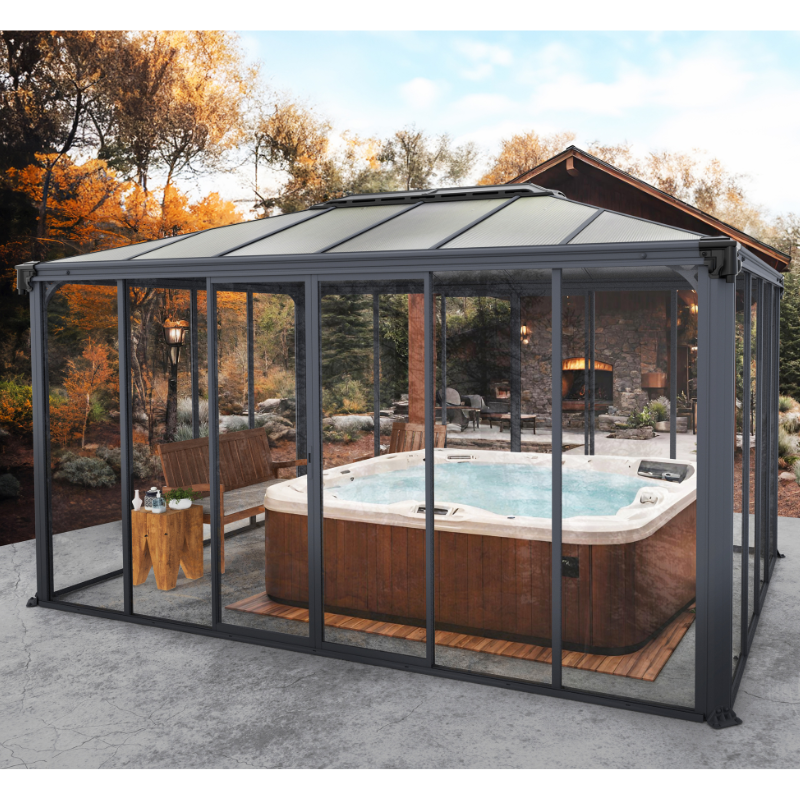 The Palram-Canopia Ledro gazebo used as a hot tub cover with glass doors and walls in an autumnal garden setting.