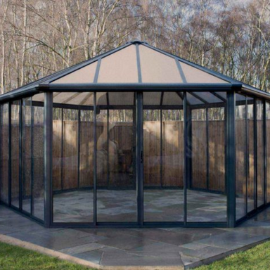 The Palram Garda conservatory 17x20 foot detached in an autumnal garden setting.