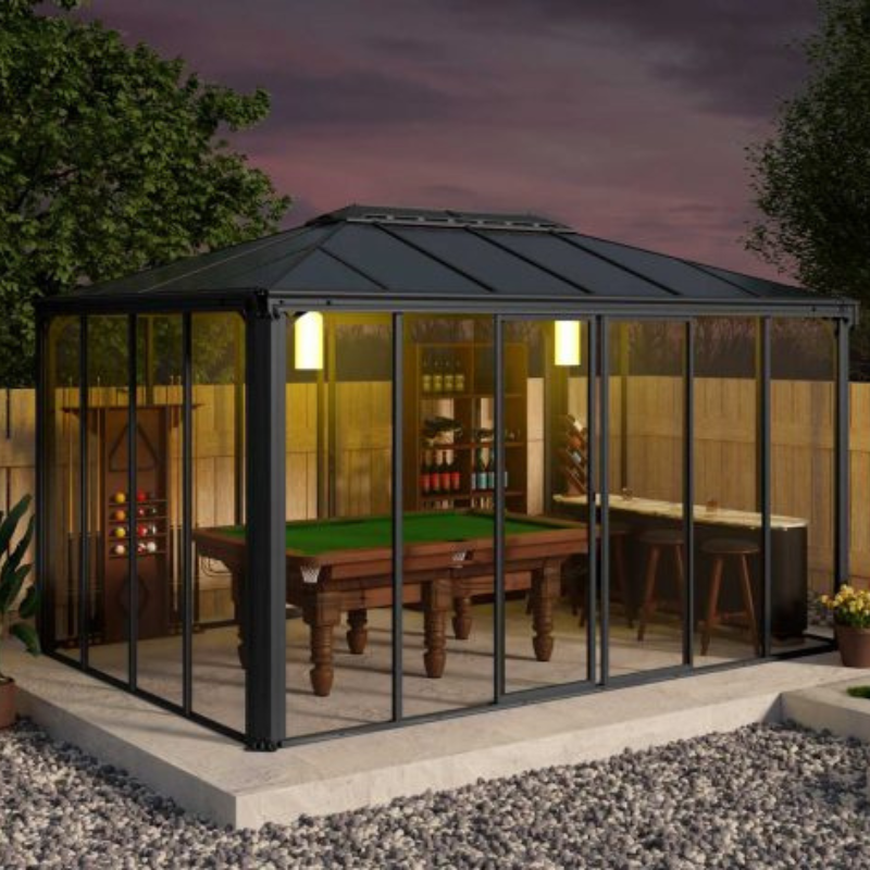 The Palram Ledro 4300 enclosed gazebo being used as a games room on a patio in a modern garden.