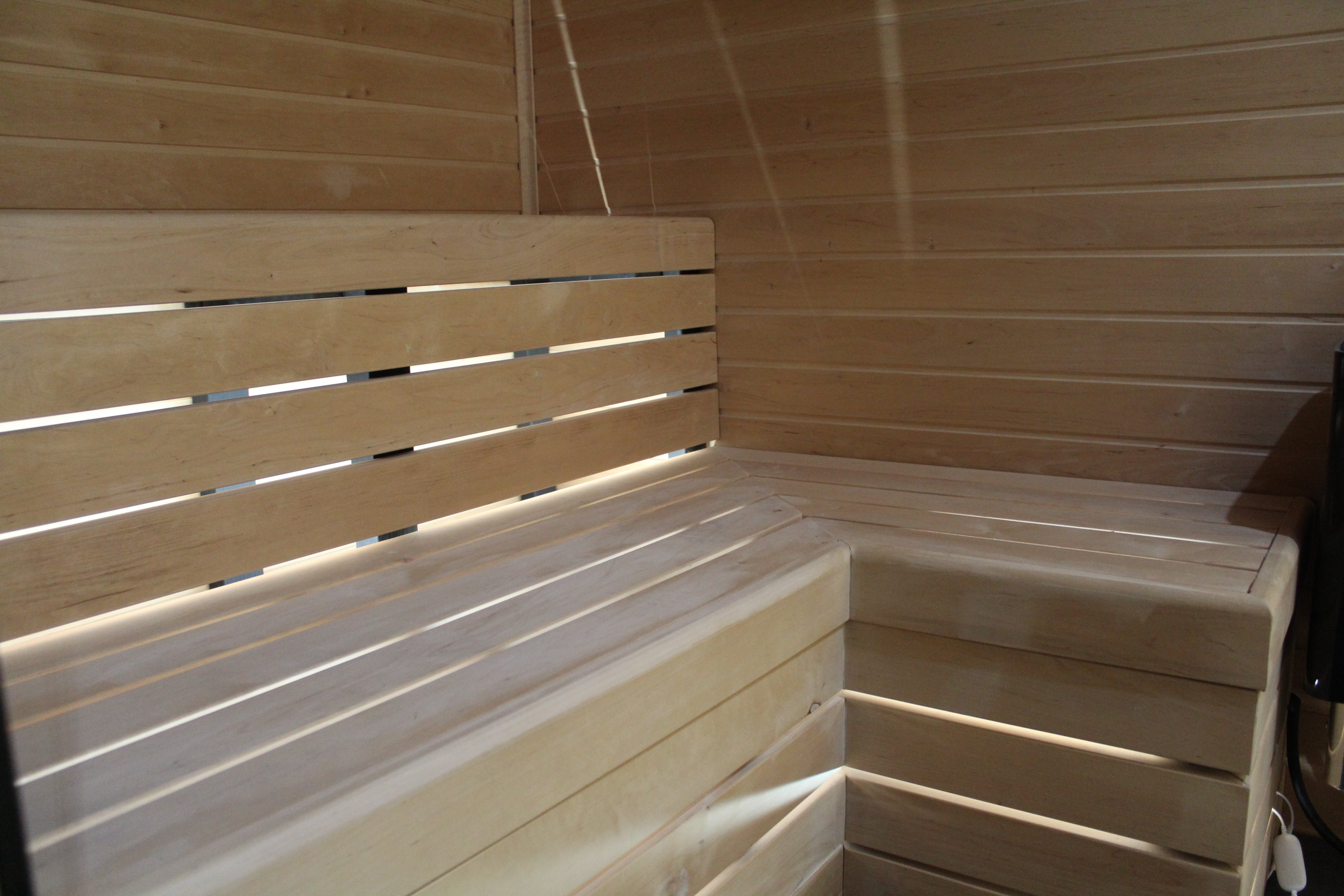 Wooden bench in a sauna with wooden walls.