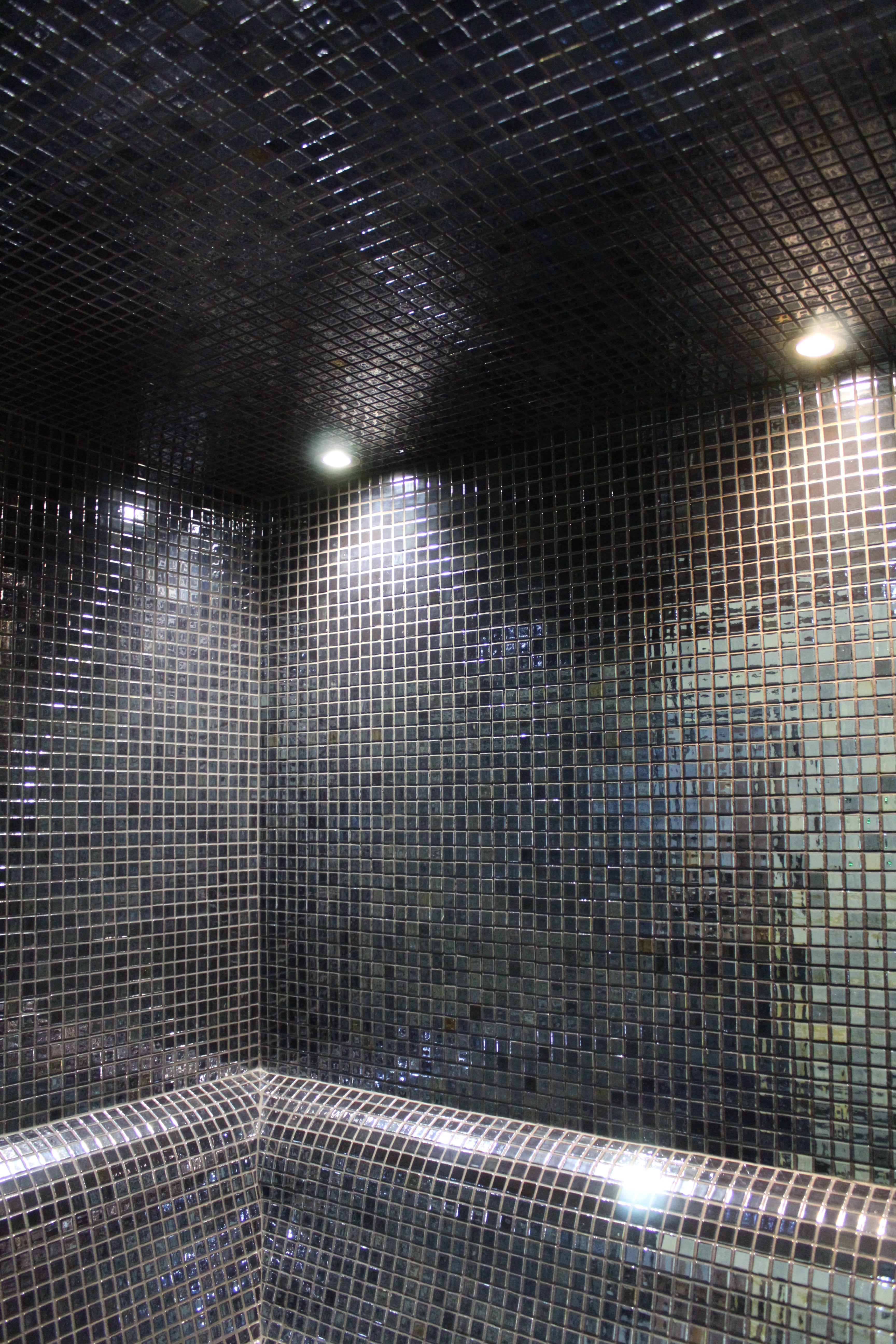 Spot lights in a mosaic tiled steam room