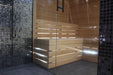 Wooden bench in a steam room with black mosaic tiles on the walls.