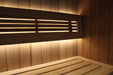 Wooden sauna bench with embedded lighting against a wooden wall.