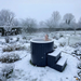 Polar Recovery Cyclone wooden ice bath in black with steps in snow-covered garden