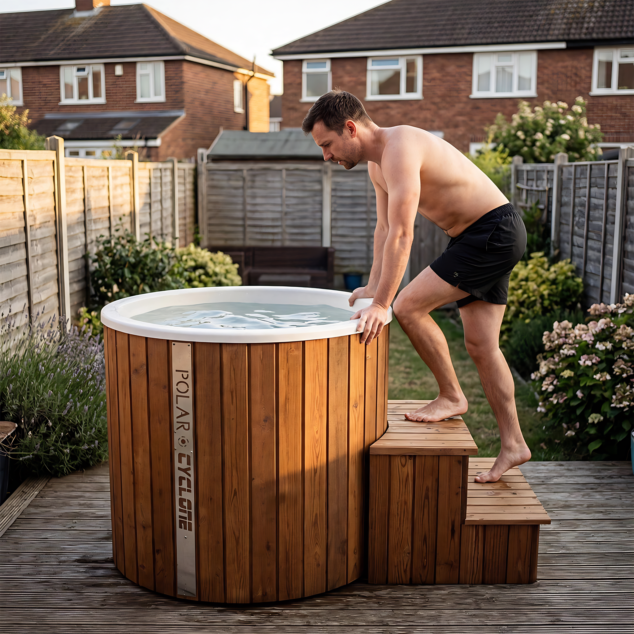 Polar Recovery Cyclone wooden ice bath in natural wood, man stepping in on garden decking