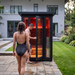 Polar Recovery Eclipse 2 person outdoor infrared sauna, couple entering on patio