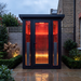 Polar Recovery Eclipse 3 person outdoor infrared sauna in courtyard at dusk
