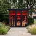 Polar Recovery Eclipse 5 person outdoor infrared sauna, three women inside in garden