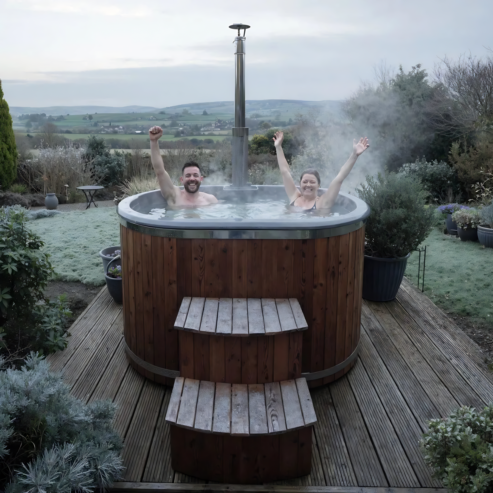 Polar Recovery Ember wood fired hot tub, couple cheering on garden decking