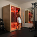 Polar Recovery Nova 2 person infrared sauna, woman stepping inside in a home gym