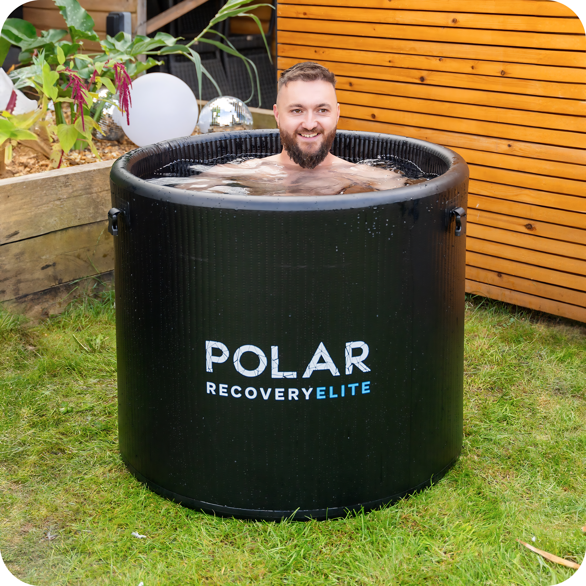 Polar Recovery Elite portable ice bath, man bathing on garden lawn
