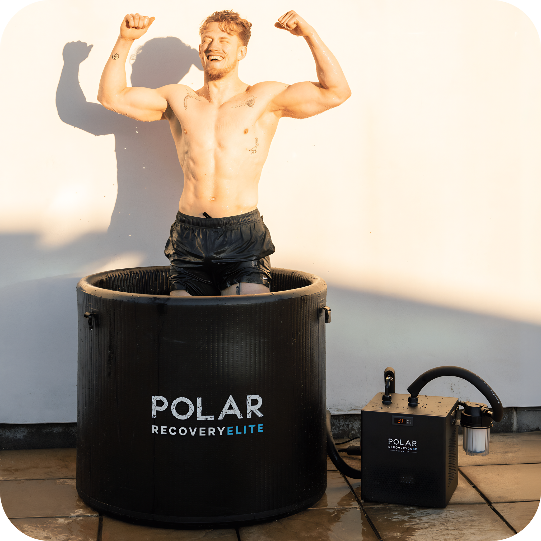 Polar Recovery Elite portable ice bath, man flexing with chiller on patio
