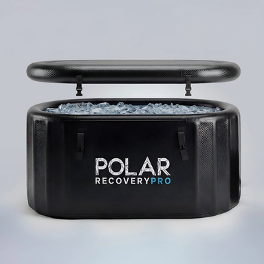 Polar Recovery Pro inflatable ice bath in black filled with ice, lid raised