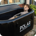 Polar Recovery Pro inflatable ice bath in black, man lying back in water