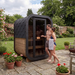 Polar Recovery Sauna Cube Mini 2 person outdoor sauna with glass front, couple on garden patio